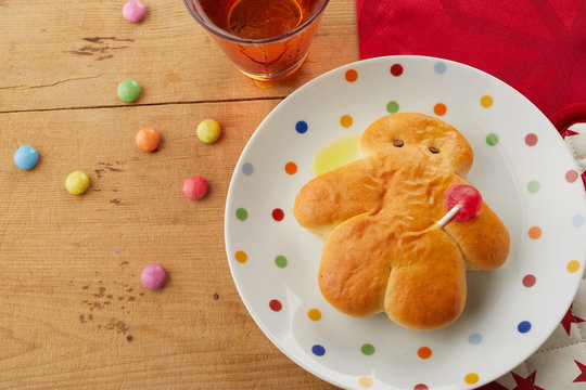 Mini Stuten bread man on a polka dot plate