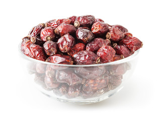 Dried wild rose berries in glass bowl isolated on white background with clipping path