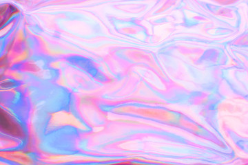 Holographic wrinkled abstract foil texture. Glittering blurred surface pack. Multicolor bright...