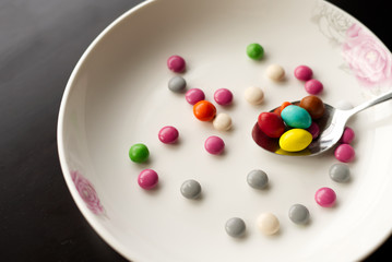 Chocolate ball candy on a dessert plate in a spoon