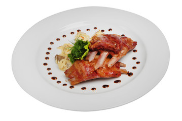 Fried rib steak with green on plate on white isolated background