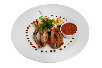 Raw pork sausages closeup view. Hunting grilled sausages on a plate isolated on white background