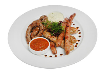 Raw pork sausages closeup view. Hunting grilled sausages on a plate isolated on white background