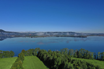 Fototapeta na wymiar Aerial view. Beautiful panorama of lake Kochelsee, Bavaria Germany. Flying on drone.