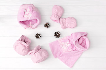 Set of children's winter or autumn clothes. scarf, hat, mittens and booted on white background.