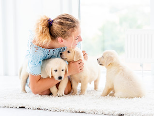 Nice girl and retriever puppies