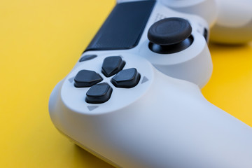 Video games white gaming controller isolated on yellow color background top view