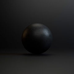 Black stone on a black background in the studio with texture