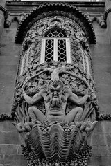 Sintra, Portugal -  February 15, 2019: The sculpture of a mythical triton on the facade of the national monument of Pena Palace (portug.: Palacio da Pena), a Romanticist castle in Sintra