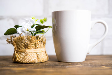 White cup mockup on wood table