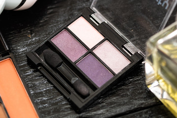 Various cosmetics on a black background. Beauty products, close up photo.