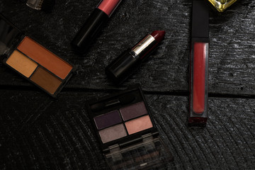 Various cosmetics on a black background. Beauty products, close up photo.