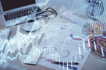 Forex market chart hologram and personal computer background. Double exposure. Concept of investment.