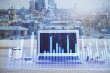 Financial chart drawing and table with computer on background. Double exposure. Concept of...