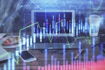 Financial graph colorful drawing and table with computer on background. Double exposure. Concept of international markets.