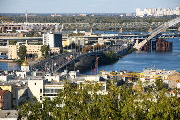 Obraz premium View of the old Podil district of the city of Kyiv and Dnipro River Dnieper with various bridges. Ukraine, September 2019