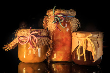 three glass jars of organic homemade jam with decoration