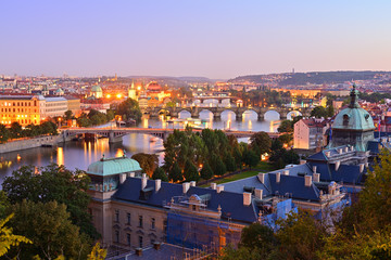 Fototapeta na wymiar Evening view over bridges on Vltava river and historical part of Prague, Czech Republic.