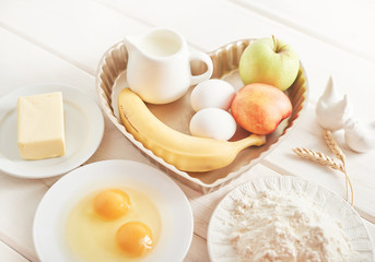 pie with banana, apples and nectarine on a white wooden background