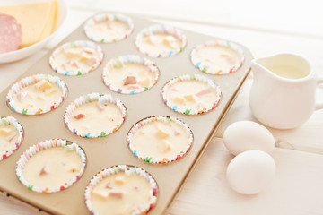 ham and cheese muffins on white wooden background