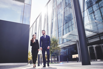 business meeting and walk of two asian Kazakh businessmen on the background of glass modern buildings
