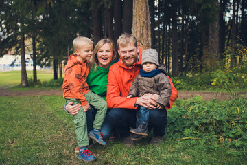 happy family in autumn forest - parents and kids smiling