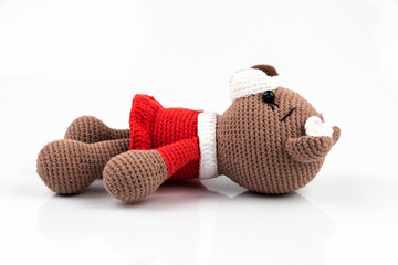 Funny handmade knitted toy bear .on white background. Amigurumi toy. Crochet stuffed animals.