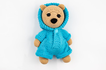 Funny handmade knitted toy bear .on white background. Amigurumi toy. Crochet stuffed animals.