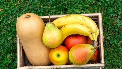 Autumn fruits in a wooden box