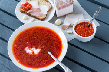 plate of borscht with lard top view, red soup,