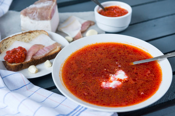 1 plate of red soup, borscht with bacon and bread