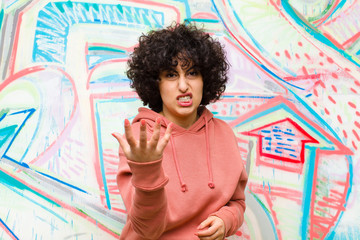 young pretty afro woman looking angry, annoyed and frustrated screaming wtf or what‚Äôs wrong...