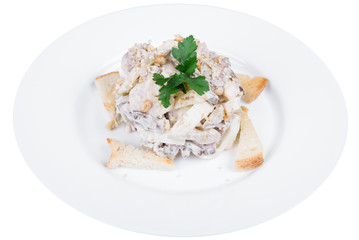 fitness salad of chicken, arugula and apple slices, with white sauce, on a plate