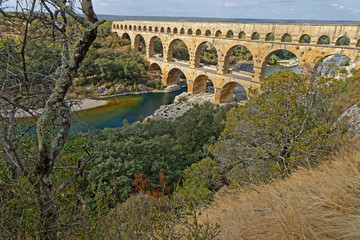 REMOULINS, FRANCE, SEPTEMBER 20, 2019 : The Pont du Gard, the highest Roman aqueduct bridge, and one of the most preserved, was built in the 1st century, added to list of World Heritage Sites in 1985.