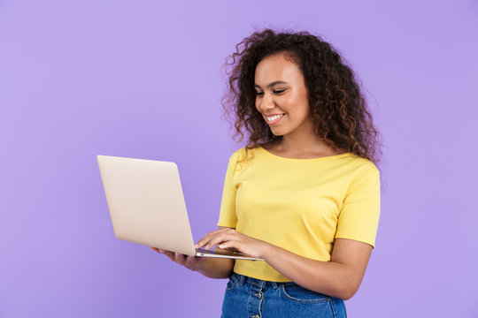 Image Of Beautiful African American Woman Holding Laptop Computer