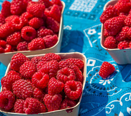 Red and Orange Raspberries in a Fruit Market