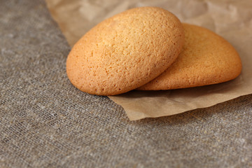 Oatmeal cookies two pieces per paper wrapping kraft and on burlap tablecloth.