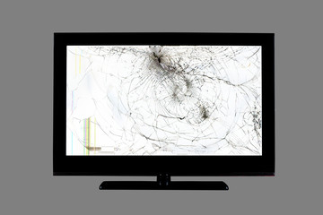 colored stripes and cracks on a black broken screen of a liquid crystal display, computer monitor or full hd television isolated on a grey background