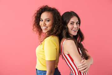 Image of charming multinational girls smiling together at camera