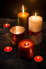 Christmas candles on wooden table. Dim light. 