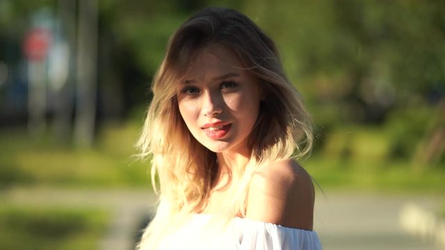 Charming young woman with a magnificent golden hair, gorgeous red lipstick and stylish look.