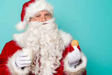 Santa Claus drinking milk and eating cookies