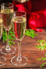 champagne and new year or christmas (champagne glass, sparkling wine and gifts on the table) menu concept. food background. copy space. Top view