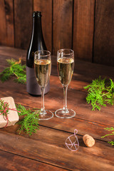 champagne and new year or christmas (champagne glass, sparkling wine and gifts on the table) menu concept. food background. copy space. Top view