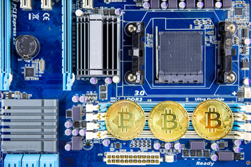 Golden Bitcoin token currency mining concept on a computer motherboard 