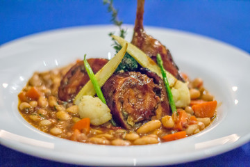 Portuguese Rabbit with White Bean and carrot Stew served in a white china dish