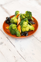 Mixture of vegetables cooked with broccoli and black mushrooms served in a plate for eating