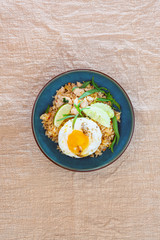 Wok rice cooked with soy sauce, vegetables and chicken pieces.