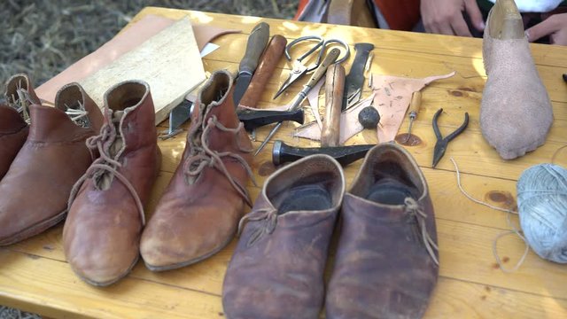 Workshop Shoemaker Middle Ages Leather. Medieval shoemaker tools. Hand Made Shoe Making. The profession of cobbler and cordwainer. 14th Century Lace Low Boots