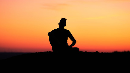 Obraz na płótnie Canvas silhouette of a man in the sunset
